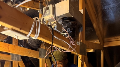 The technician giving the thumbs-up behind the furnace. Photo