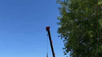 Crane moving a package unit to the roof Photo